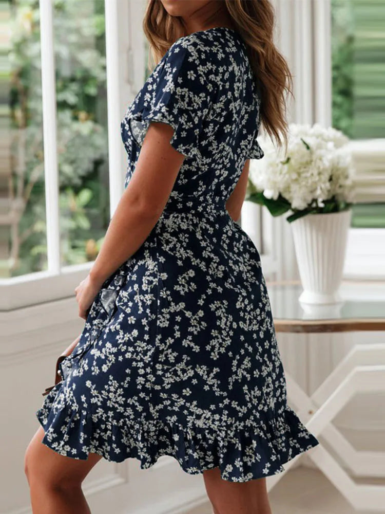 Full-length view of green floral wrap dress paired with neutral accessories